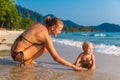 A young mother with a child having fun on a tropical beach.. Nat Royalty Free Stock Photo