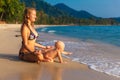 A young mother with a child having fun on a tropical beach.. Nat Royalty Free Stock Photo