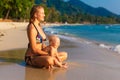 A young mother with a child having fun on a tropical beach.. Nat Royalty Free Stock Photo