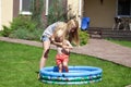 Young mother with a child near a rubber children's pool Royalty Free Stock Photo