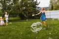 Young Mother and children blowing soap bubbles Royalty Free Stock Photo