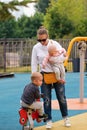 Young mother with children on playground