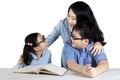 Young mother with children studying together Royalty Free Stock Photo