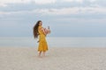 Young mother circling a child in her arms by the sea. Happy life with children