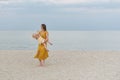 Young mother circling a child in her arms by the sea. Vacation with children