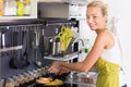 Young Mother Cooking at Home. Royalty Free Stock Photo