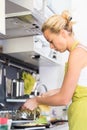 Young Mother Cooking at Home. Royalty Free Stock Photo