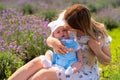 Young mother cuddling her cute baby son outdoors Royalty Free Stock Photo