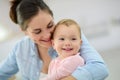 Young mother cuddling her smiling baby Royalty Free Stock Photo