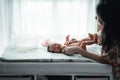 Young mother and cute baby bathing