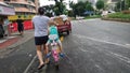 The young mother cycled her child down the road Royalty Free Stock Photo