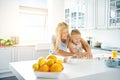 Young mother and daughter baking together