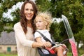 Young mother and daughter on bicycle ride in the park Royalty Free Stock Photo