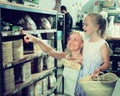 Mother with daughter buy corn cakes in store