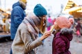 Young mother and daughter eating white chocolate covered fruits on skewer on traditional German Christmas market Royalty Free Stock Photo