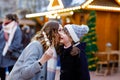 Mother and daughter eating white chocolate covered fruits and strawberry on skewer on traditional German Christmas Royalty Free Stock Photo