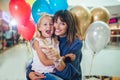 Mother and daughter having fun in shopping mall toghether