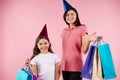 Young mother and daughter in party caps