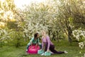 a young mother and daughter perform yoga exercises in the park on a gym mat. healthy lifestyle.