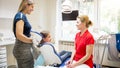 Young mother with daughter visiting dentist office for checkup