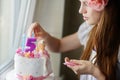 Young mother decorating daughters birhtday cake Royalty Free Stock Photo