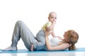 Young mother does fitness exercises together with baby boy isolated on white background Royalty Free Stock Photo