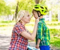 Young mother dresses her son bicycle helmet Royalty Free Stock Photo