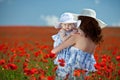 Young mother and her baby-girl in poppy field Royalty Free Stock Photo