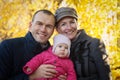 Young mother and father and baby girl have fun in autumn Royalty Free Stock Photo