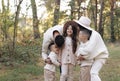 Young mother, father with daughter and sons are walking, having fun in autumn forest. Family holding hands enjoying time Royalty Free Stock Photo