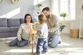 Young mother, father and their little daughter spend time at home in cozy children& x27;s room. Royalty Free Stock Photo