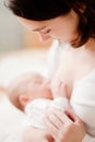 Young mother feeding baby