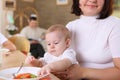 A young mother feeding baby at home Royalty Free Stock Photo