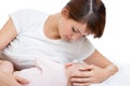 Young mother feeding breast her baby on bed Royalty Free Stock Photo