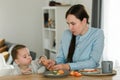 Young mother feeding her baby son with fruit Royalty Free Stock Photo