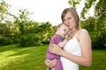 Young mother in the garden with a baby Royalty Free Stock Photo