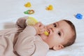 Young mother hand holding comb and brushing her baby. Close up Mother care. Concept of parenthood Royalty Free Stock Photo