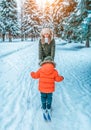 Young mother is happy and laughs, encouraging her child a boy of 4-6 years old, first steps of skiing on children. In Royalty Free Stock Photo