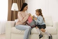 Young mother helping her little child get ready for school at home Royalty Free Stock Photo