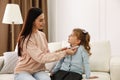 Young mother helping her little child get ready for school at home Royalty Free Stock Photo