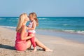 Young mother and her adorable daughter enjoying day at beach Royalty Free Stock Photo