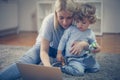 Young mother and her baby boy watching cartoons online. Royalty Free Stock Photo