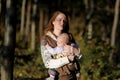 Young mother with her baby in a carrier Royalty Free Stock Photo