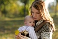 Young mother with her baby in a carrier Royalty Free Stock Photo