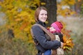 Young mother and her baby in a carrier Royalty Free Stock Photo