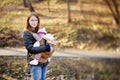 Young mother and her baby in a carrier Royalty Free Stock Photo