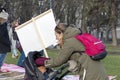 Young mother, her baby child and activists with placard and banners protest against animal abuse