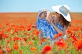 Young mother and her baby-girl in poppy field Royalty Free Stock Photo