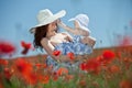 Young mother and her baby-girl in poppy field Royalty Free Stock Photo