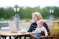 Young mother with her baby working or studying on laptop Royalty Free Stock Photo